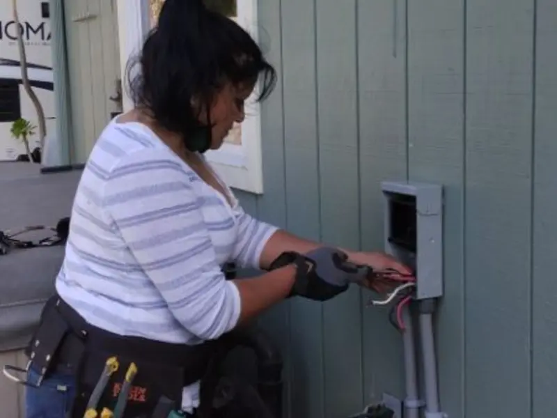 Licensed electrician wiring an exterior subpanel in Metropolis